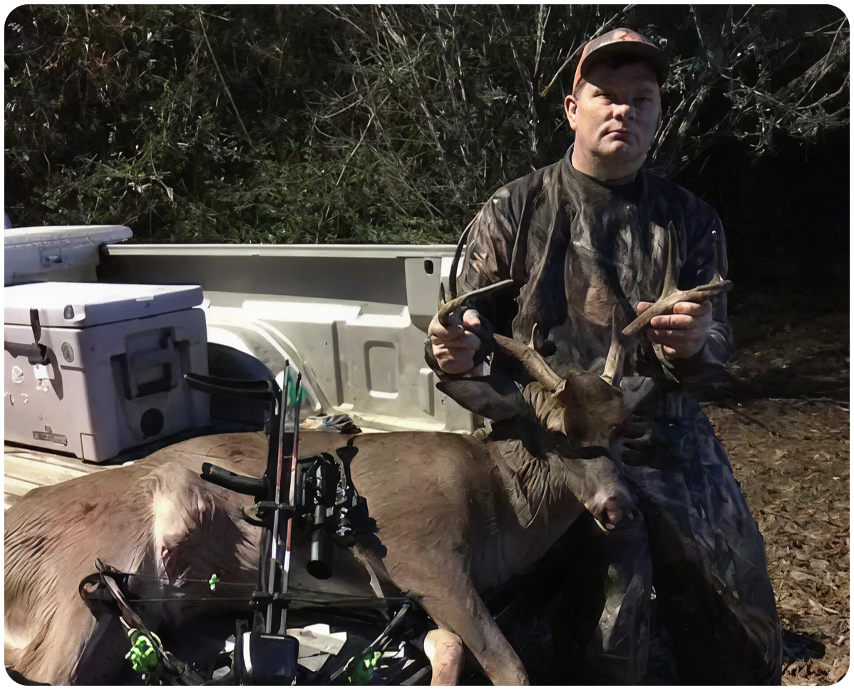 Man in camouflage with deer catch